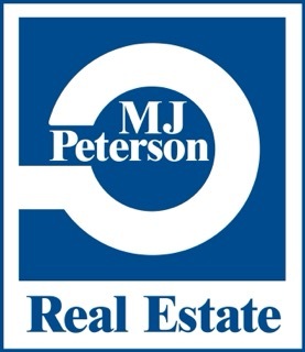 A blue and white logo for MJ Peterson Real Estate.
